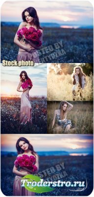      / Girls in a field with flowers - stock photo