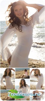        / Girl in white dress on the beach - Stock Photo